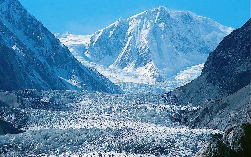 The vast, crevassed ice of the Batura Glacier below a snow-capped Karakoram peak, one of the longest non-polar glaciers on earth, Upper Hunza