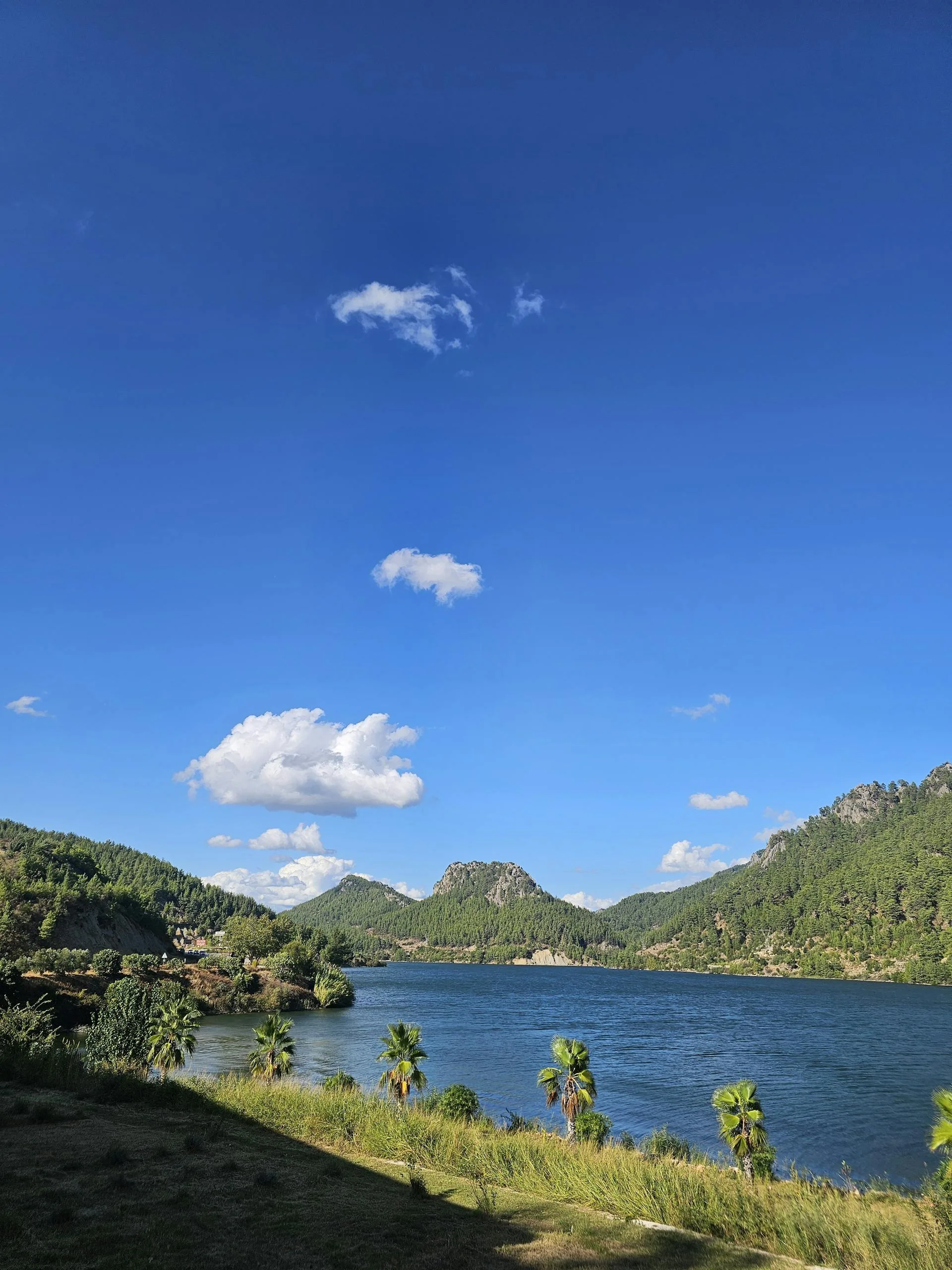 A stunning lake view with blue sky and mountains