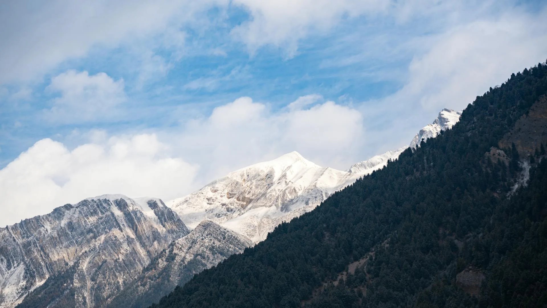 Snow-capped mountains rising dramatically from the valley