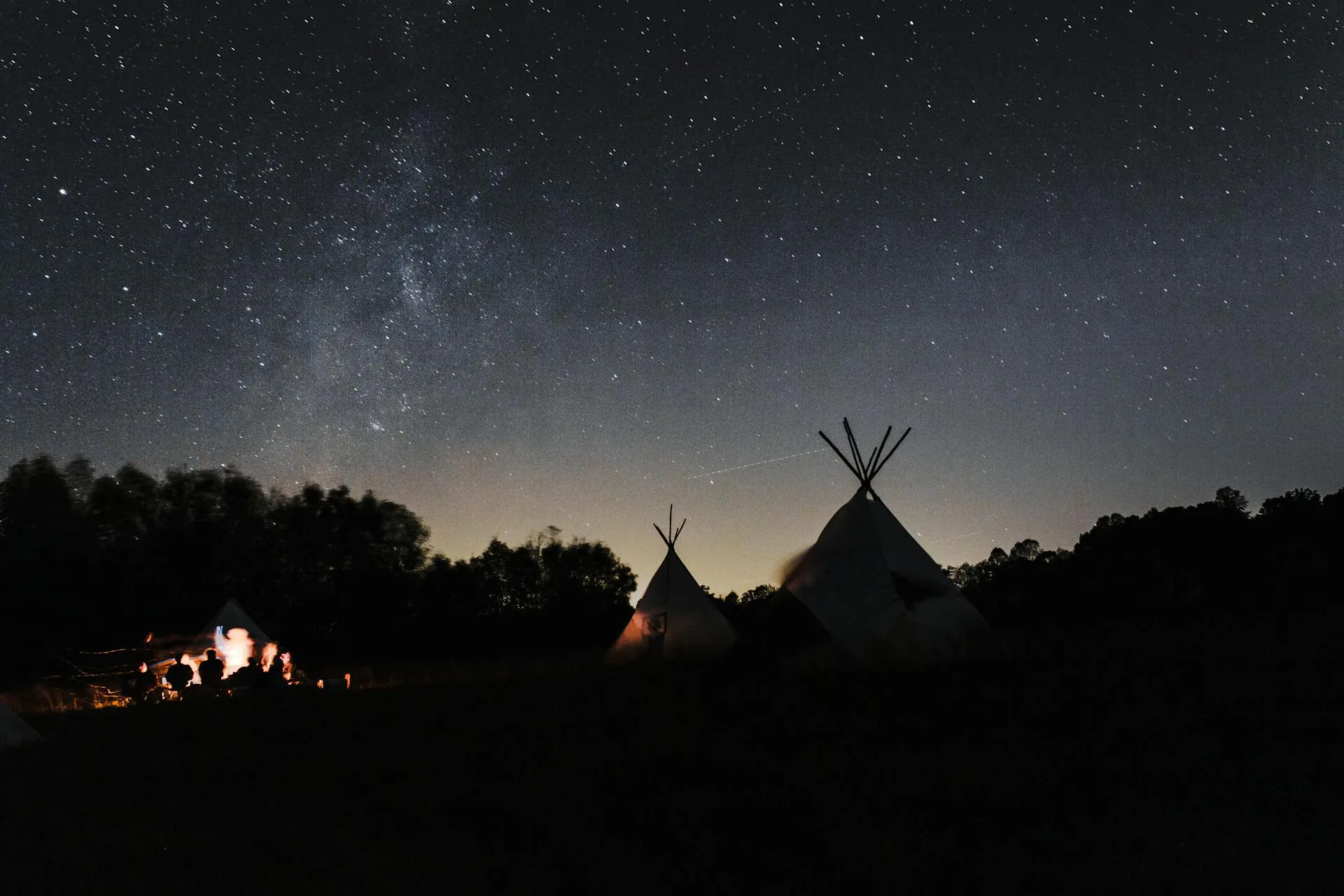 A tent pitched under a spectacular starry night sky