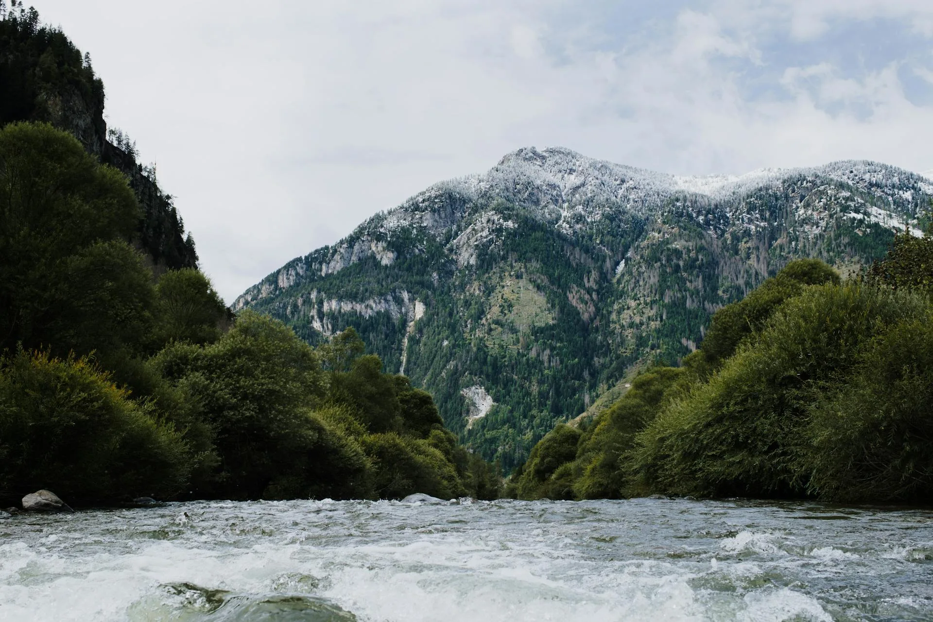 Mountain landscape with flowing river in valley