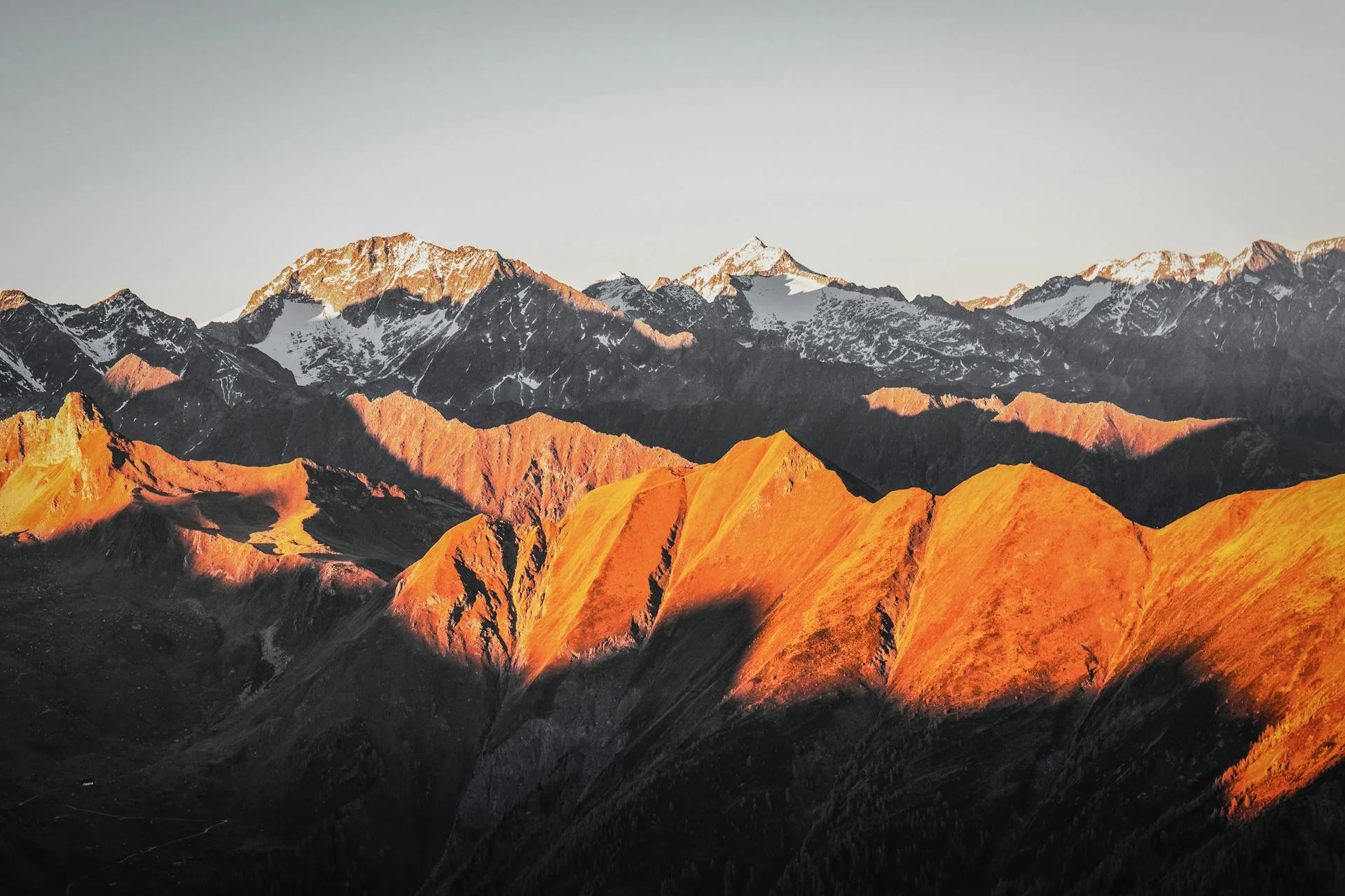 Snow-capped mountain range in golden light