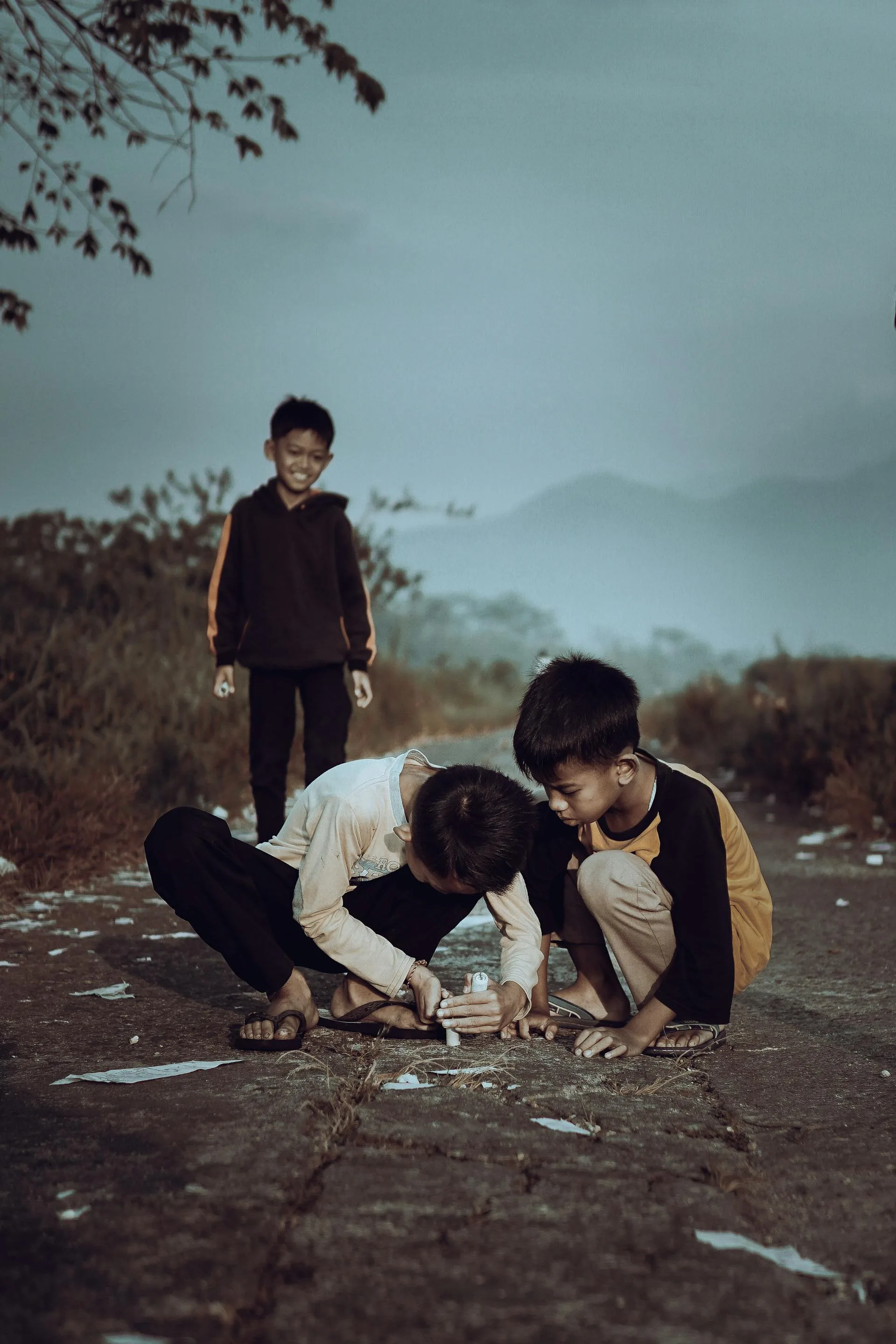 Boys playing on village road with mountains