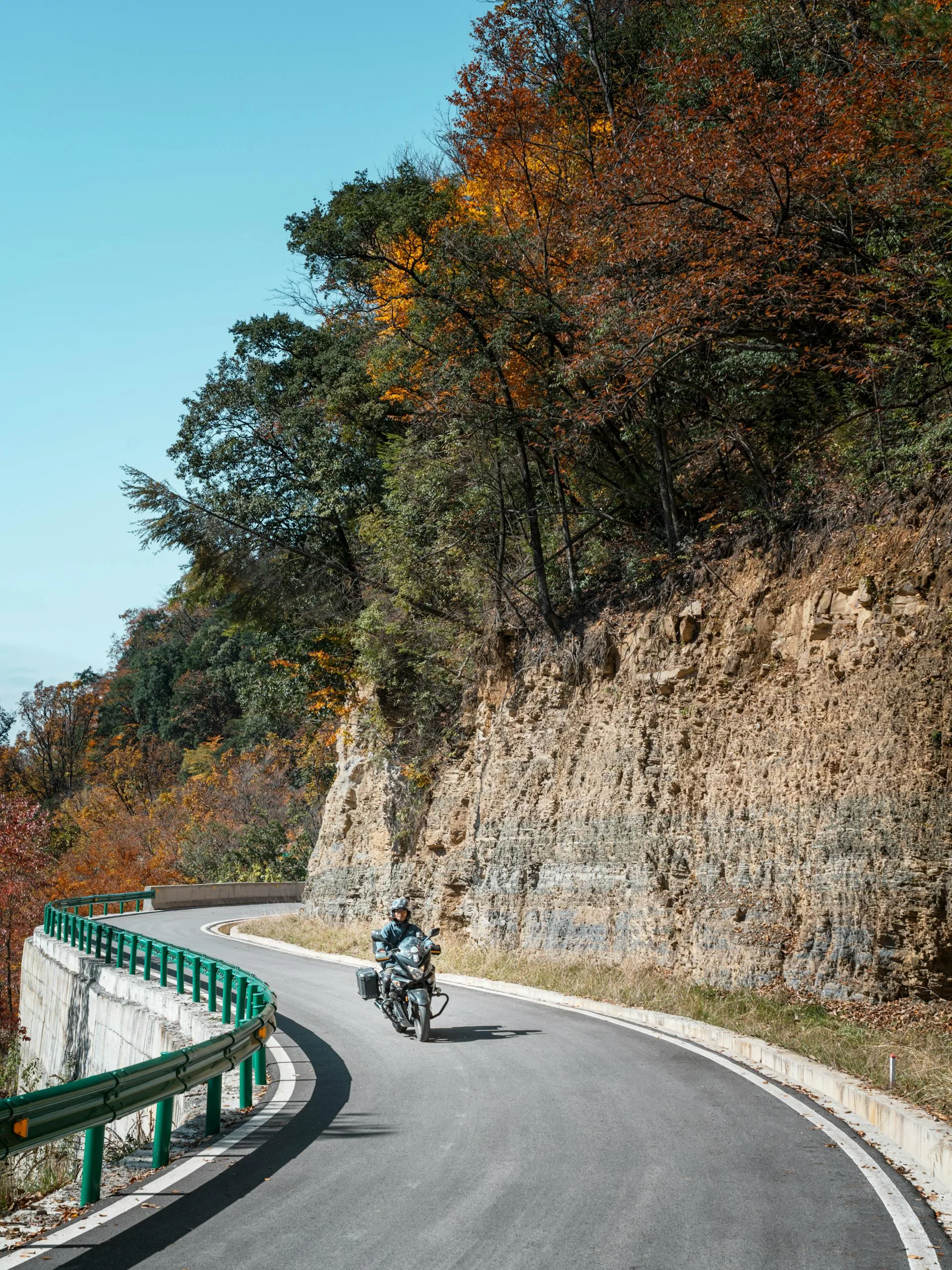 Motorcyclist autumn road