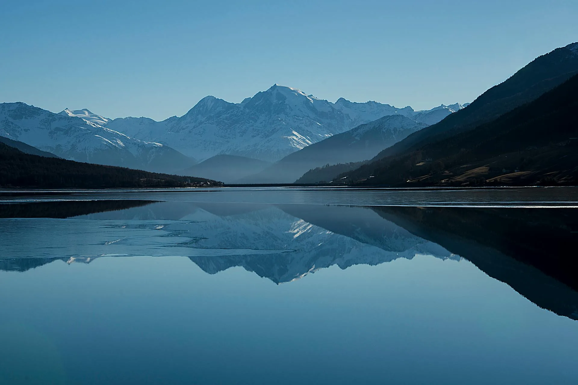 Calm lake nestled between towering mountains