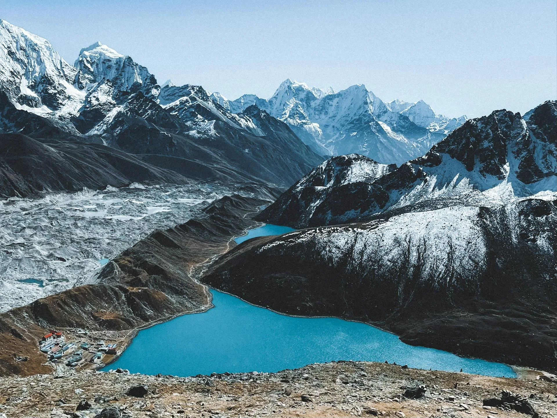 A stunning aerial view of turquoise glacial lake and mountains