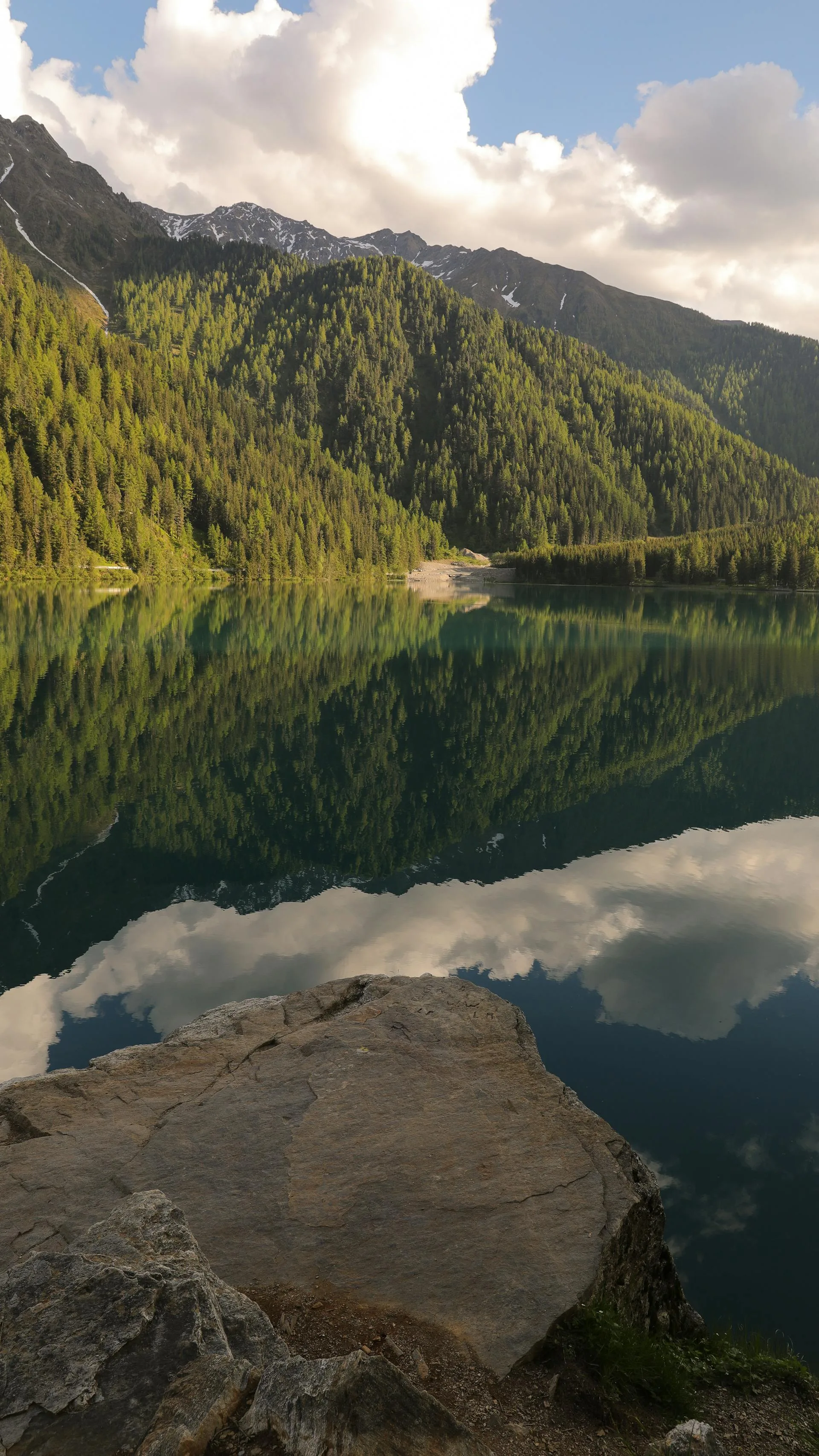 Mountain peaks reflected perfectly in a glacial lake