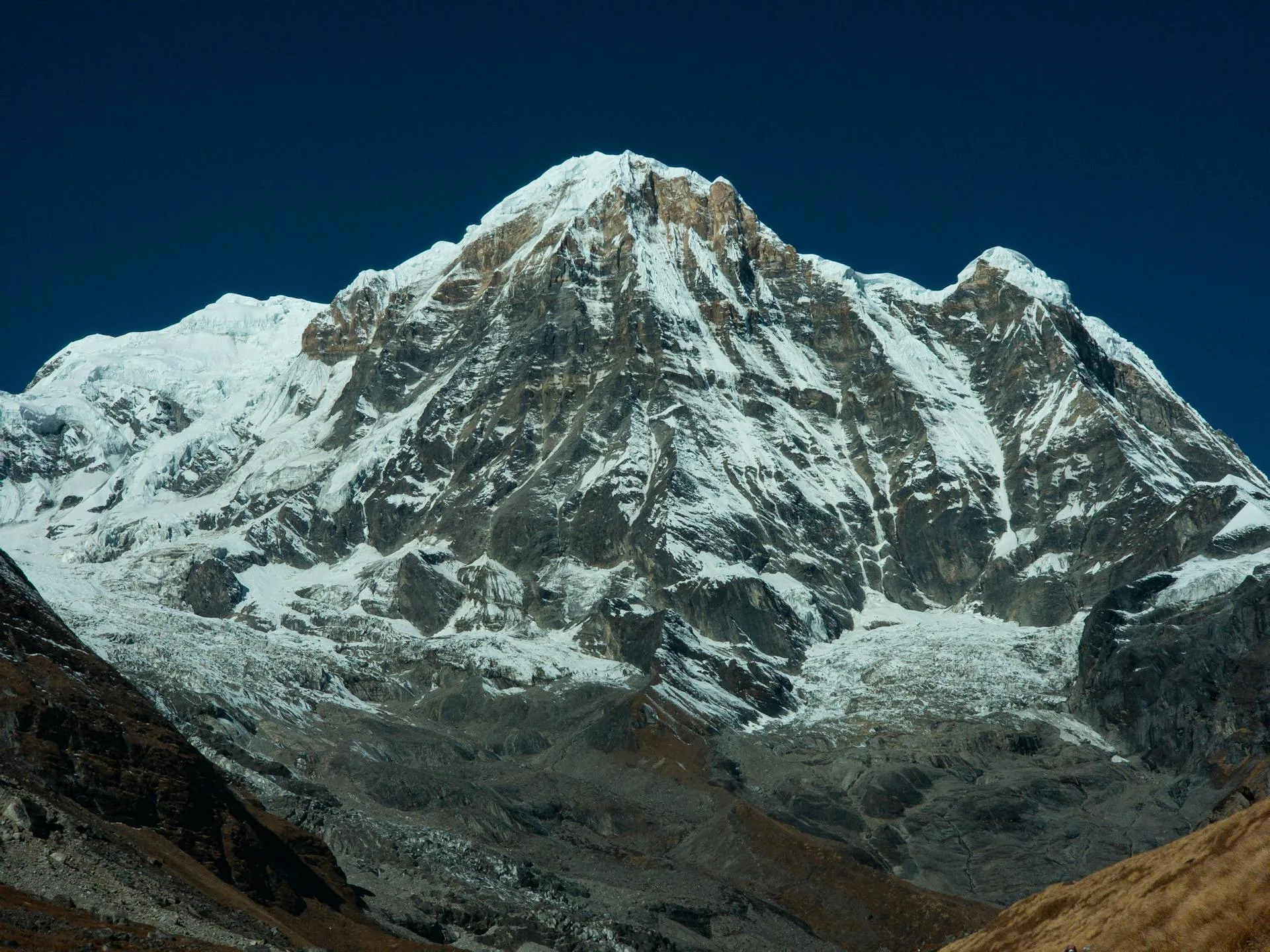 A majestic snow-covered peak rising above the clouds