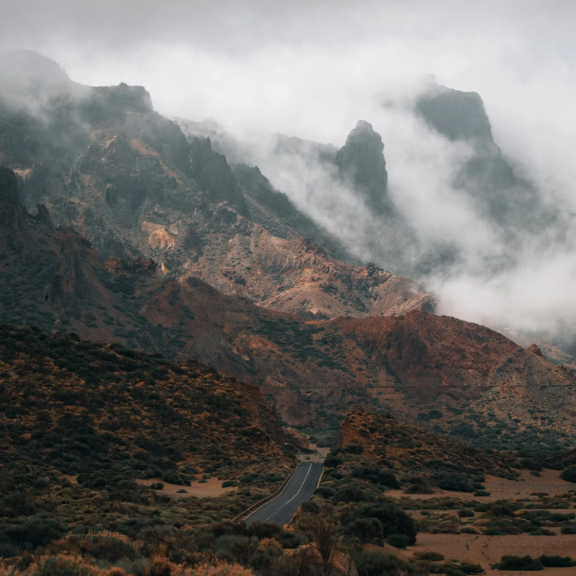 Road winding under arid mountain terrain