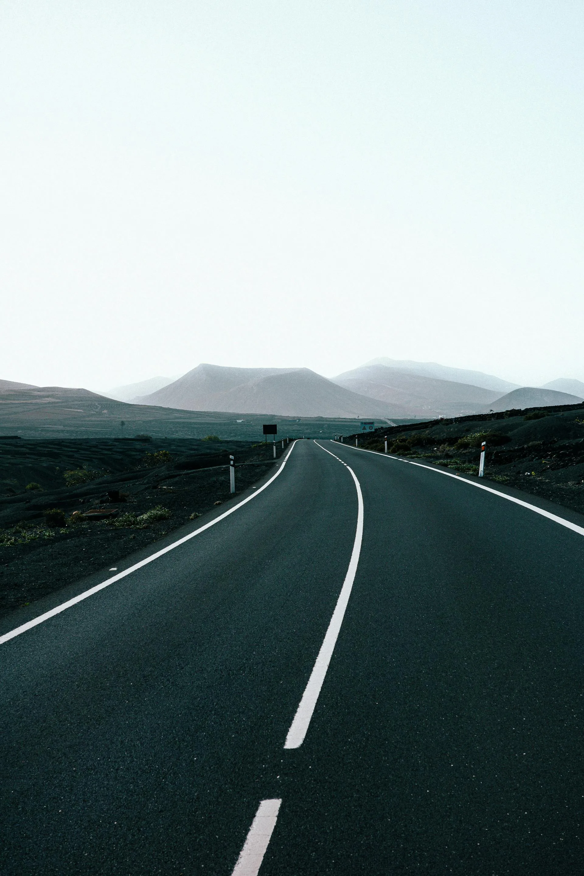 Road through barren desert mountain landscape