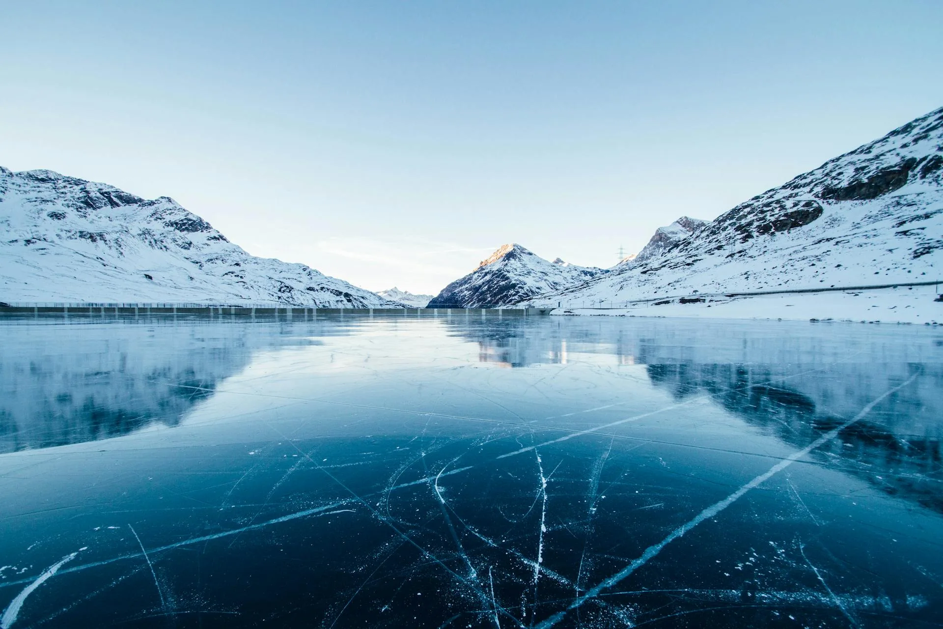 An icy glacial river flowing through the mountain valleys