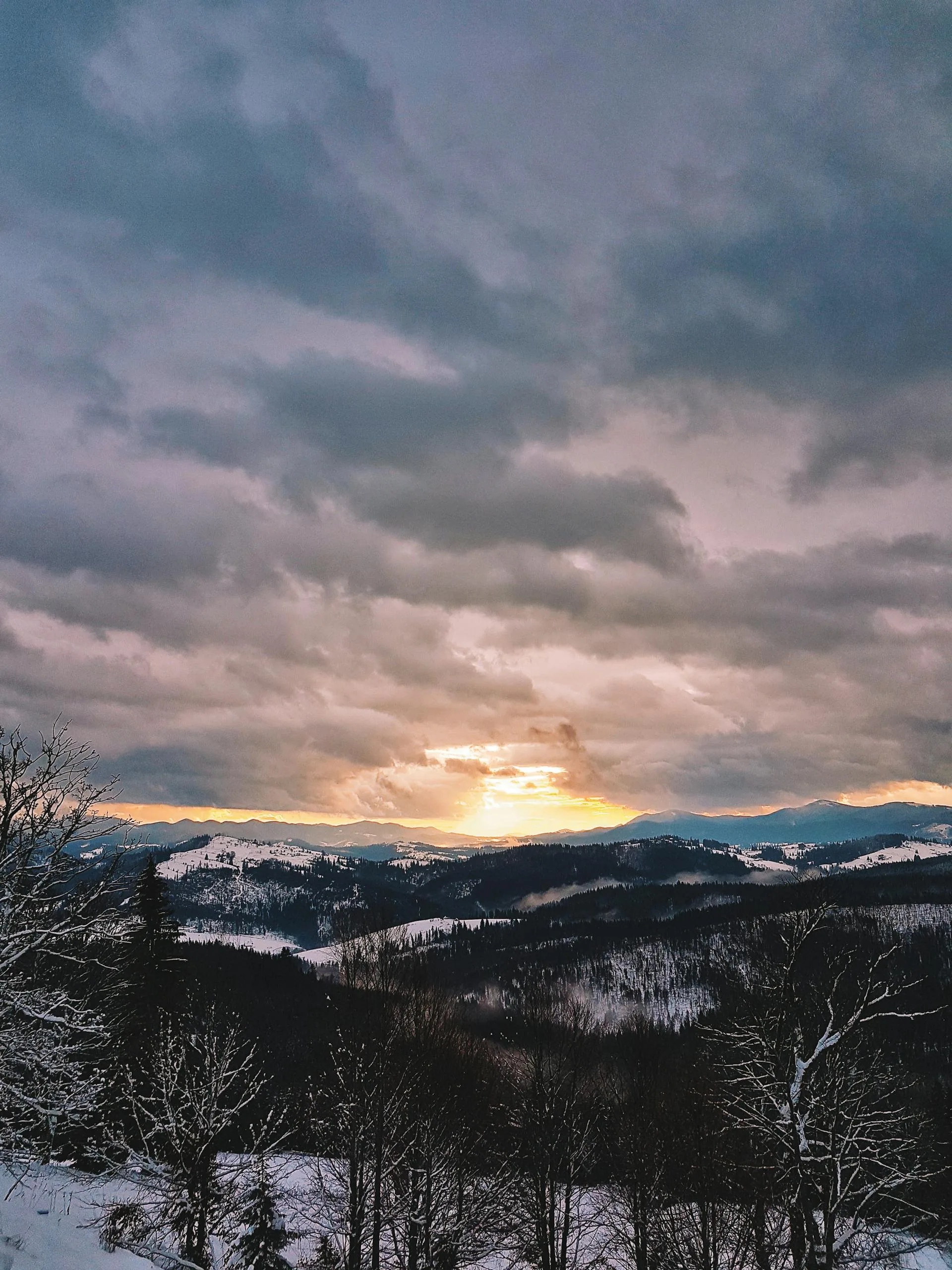 Snow-covered mountains bathed in golden sunrise light